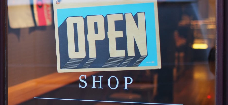 open sign in front of a store window